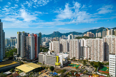 High angle view of buildings in city against sky