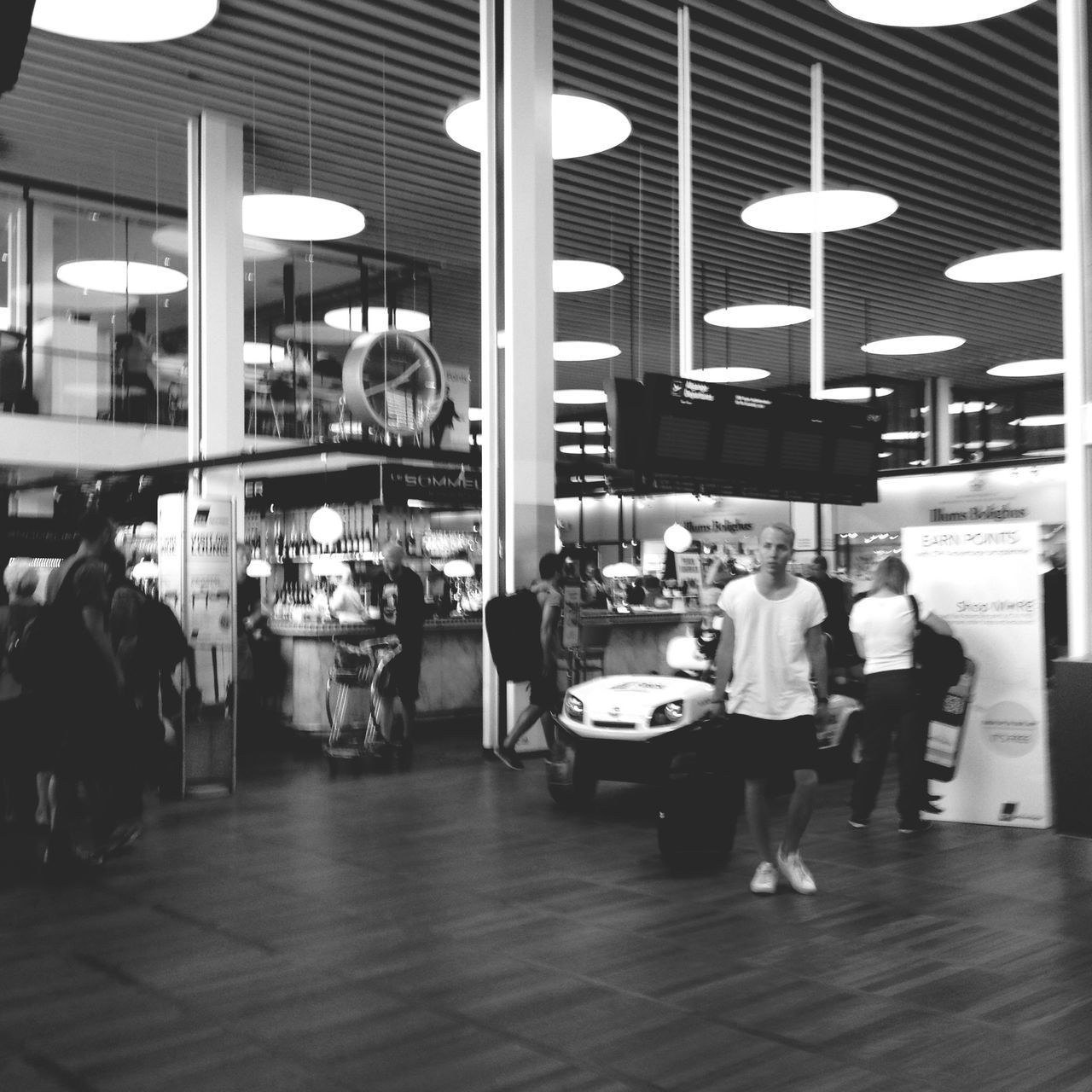 indoors, table, chair, architecture, restaurant, built structure, person, lifestyles, men, city, sitting, leisure activity, cafe, building exterior, incidental people, city life, glass - material, window, flooring