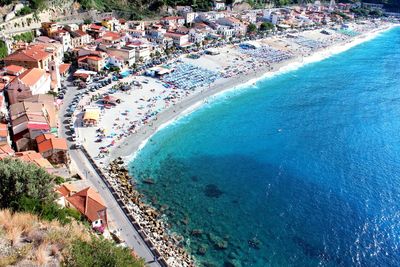 High angle view of people at swimming pool against sea