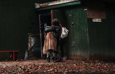 Rear view of people standing by building