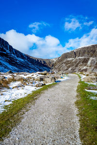 Scenic view of snowcapped mountains against blue sky