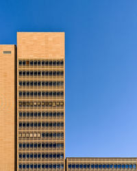 Low angle view of building against clear blue sky