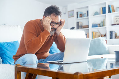 Young woman using laptop at table