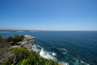 Scenic view of sea against clear blue sky