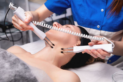 Midsection of doctor examining patient at clinic