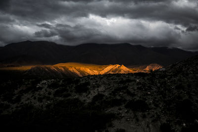 Scenic view of mountain against cloudy sky