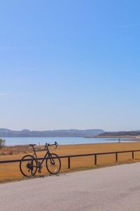 Bicycles on beach against clear sky