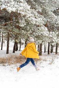 Rear view of woman on snow covered land