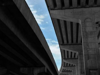 Low angle view of bridge against sky in city