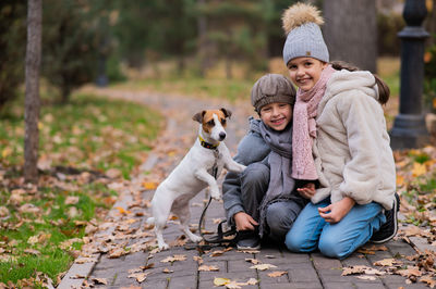 Side view of woman with dog on street