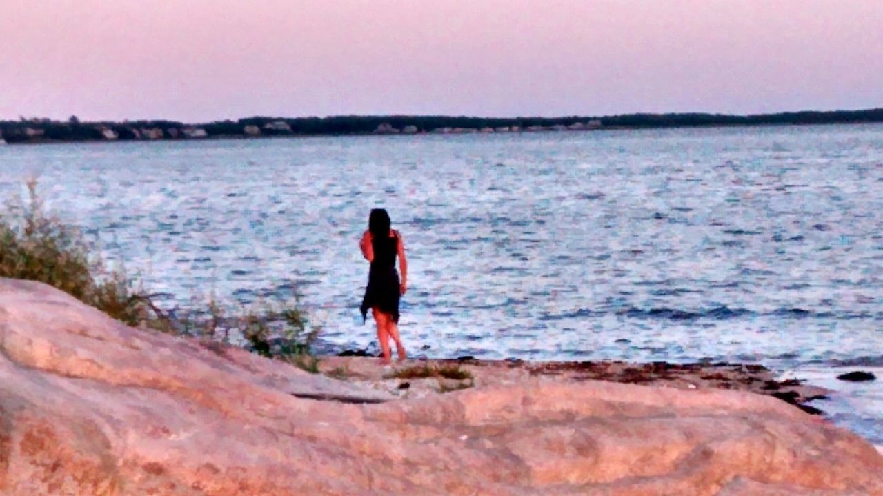 FULL LENGTH OF WOMAN STANDING ON BEACH