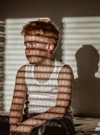 Young man looking away while sitting