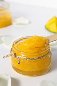 Sugar scrub for cleansing and peeling close-up on a white wooden table. homemade cosmetic product 