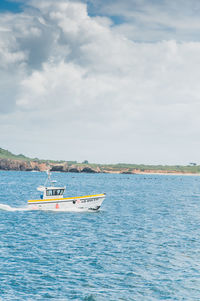 Boat sailing in sea against sky