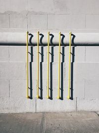 Yellow painted pipes on wall