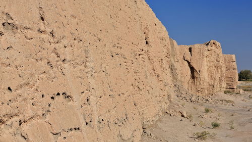 Rock formation on land against clear sky