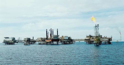 Commercial dock by sea against sky