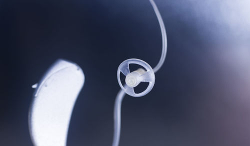 Close-up of electric lamp against blue background