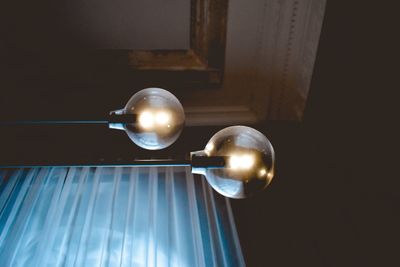 Low angle view of illuminated light bulb at home