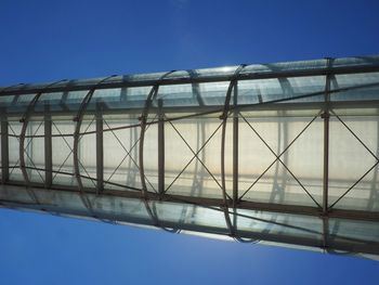 Low angle view of bridge against blue sky