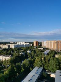 High angle view of buildings against blue sky