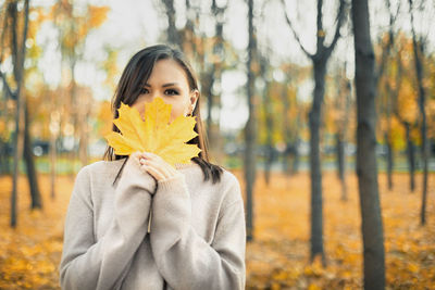 Portrait of young woman holding flower