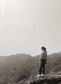 Man standing on mountain against sky