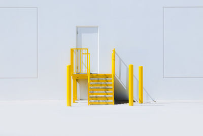 Yellow staircase at door of building