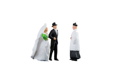 Rear view of couple kissing against white background