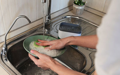 Cropped hand of woman holding food