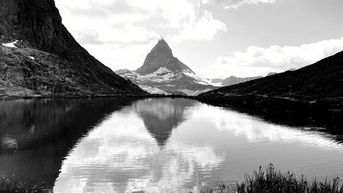 Scenic view of lake and mountains against sky