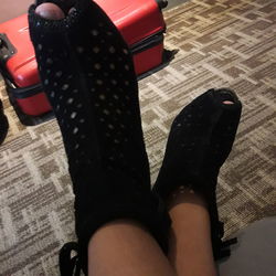 Low section of woman wearing shoes on floor