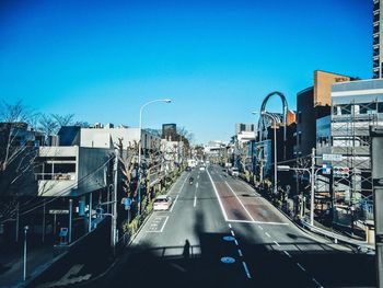 Road in city against clear sky