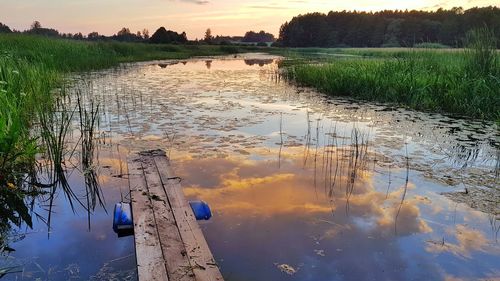 Scenic view of lake against sky at sunset