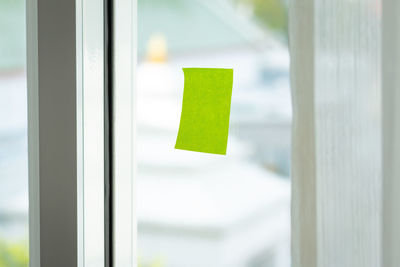 Close-up of adhesive note on glass window