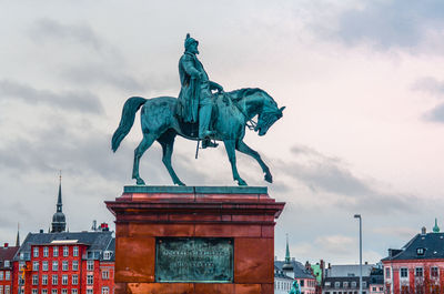 Low angle view of statue against cloudy sky