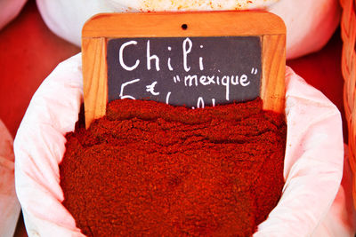 High angle view of chili powder in sack at market for sale