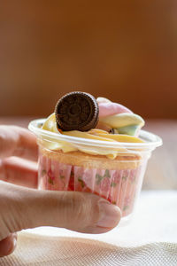 Close-up of hand holding ice cream