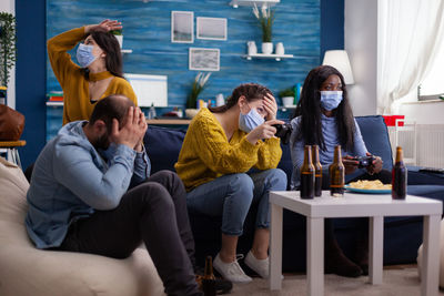 People wearing mask enjoying at home