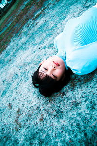 Portrait of a smiling woman lying in swimming pool