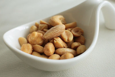 Close-up of peanuts in spoon on table