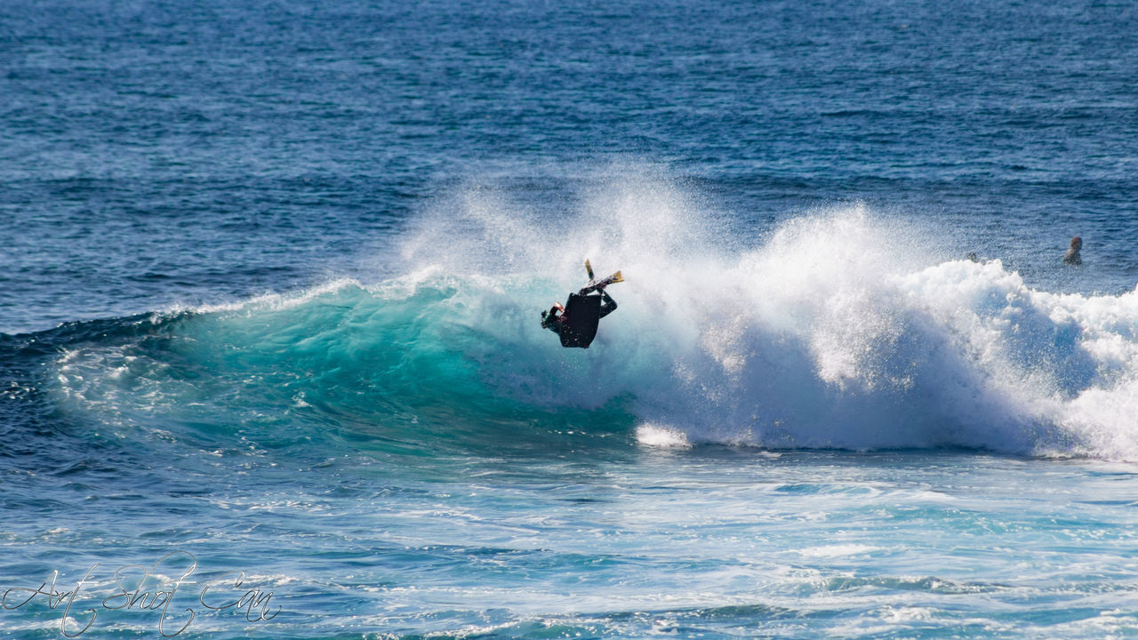 PERSON SURFING ON SEA