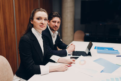 Portrait of coworker sitting at office