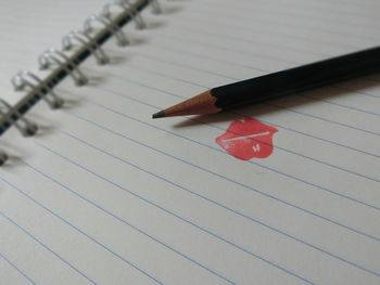 High angle view of pencil on book 