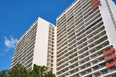 Low angle view of modern building against blue sky