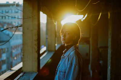 A young woman posing while being lit by setting sun