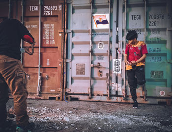 Rear view of men standing at entrance