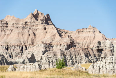 Panoramic view of rocky mountains against clear sky