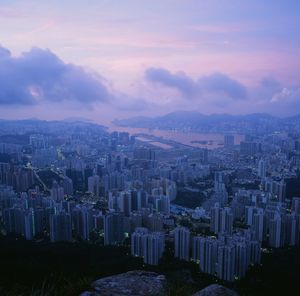 Aerial view of buildings in city at sunset