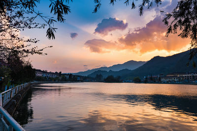 Scenic view of river against sky during sunset